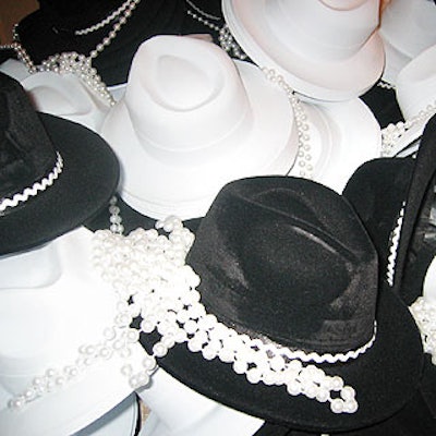 Guests were invited to pick up a fedora or a strand of pearls on the their way into the party.