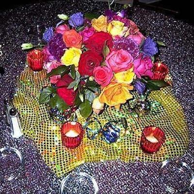 Each table featured colorful metallic tablecloths and ribbons and a floral centerpiece by Susan Edgar Design.