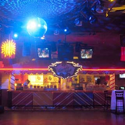 A disco ball and colored lights set the tone in Cafe Iguana's main room for the 80's party.