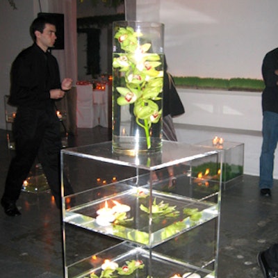 Lucite towers filled with water and orchids decorated the cocktail area.