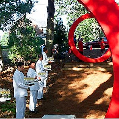 Waiters from Olivier Cheng Catering and Events offered guests champagne along the wooded pathway.