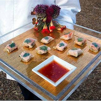 Olivier Cheng Catering and Events served guests hors d'oeuvres outdoors as they walked through the exhibition. Offerings included these salmon and Chinese parsley pesto packages.