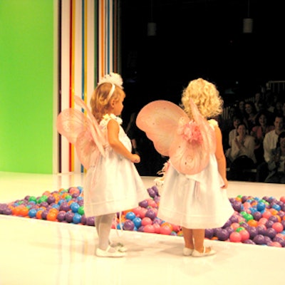 Kid models in Children's Place dresses and faux wings posed for attendees at the Children's Place fashion show at the AMF Chelsea Piers Lanes.