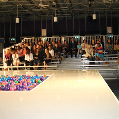 Attendees sat on aluminum bleaches that flanked both sides of the runway.