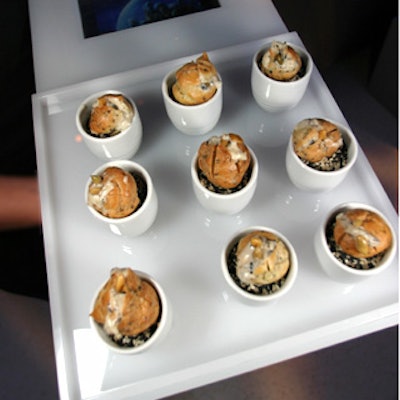 The nibbles included wild mushroom profiteroles served on milk white Plexiglas trays with portable DVD players inside showing video clips of interplanetary travel.
