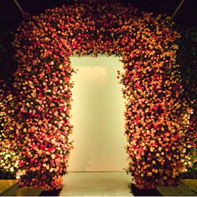 The arch for the Marc Jacobs' runway show was created using thousands flowers and designed by Raul Avila. The white backdrop folded open to allow guests to enter the after-party space. (Photo by Tom Kletecka)