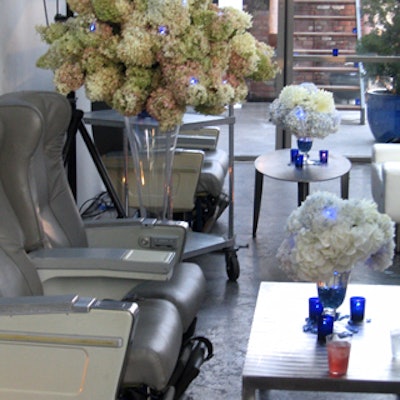 It's hard to make airline seats look good, but they were pretty appealing when paired with steel coffee tables and pastel-colored flower arrangements.