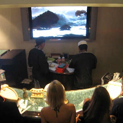 A group of guests waited for the chefs to prepare more sushi at the Sony Qualia launch.