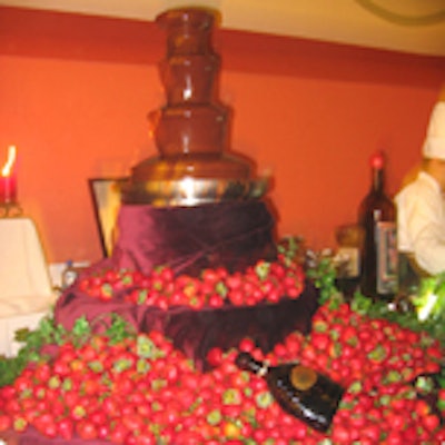 A chocolate fountain surrounded by an enormous mound of summer strawberries was displayed at the Timpano Italian Chophouse station.