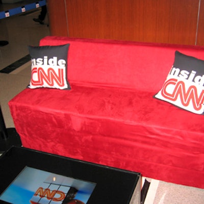 EventStyle created small, wedge-shaped sofas and covered them in red suede and custom designed throw pillows with the Inside CNN logo.