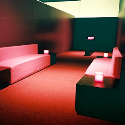 The first-floor south gallery provided a sleek lounge space—its walls were bare because it was between exhibitions—where long benches flanked by low tables sat across from one another.
