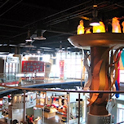 A massive Olympic torch extends through the centre of the five-story space.