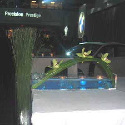 See-through vases holding simple floral designs hung off the tables in the Vista BMW showroom.