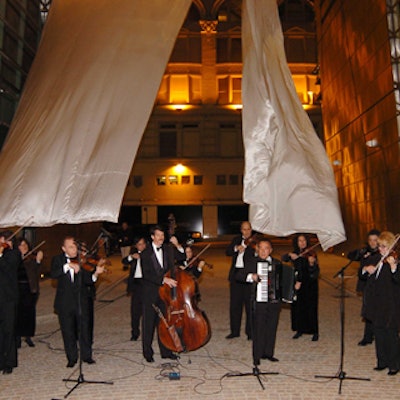 In the courtyard during the cocktail hour, a music ensemble provided by Orion Music consisting of 18 violins, one accordion player, and one upright bassist, played New York tunes such as 'Lullaby of Broadway.' (Photo courtesy of Patrick McMullan)