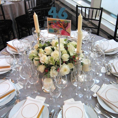Robert Isabell Inc. created floral centerpieces of roses and berries for the dinner tables. To mark table numbers, Bradley Associates procured postcards of artwork from students in the Studio in a School program.