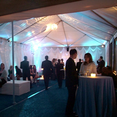 A tent from Starr Tents adjacent to the gallery housed two bars, two disco balls, and dozens of white votive candles in glass holders.