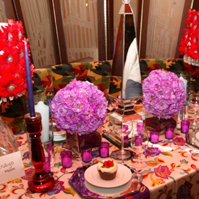 At an afternoon tea event to benefit Flowerpower at Monkey Bar, Indigo Moon created a bridal shower table with lampshades covered with red gerbera blossoms and globes of purple flowers.