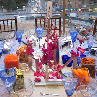 For the kickoff gala dinner for Real Simple's Get Organized New York tag sale in Central Park, Musters & Company covered the tables with pale blue cloths accented with pastel-colored runners; bright fuchsia orchids in sculpted, brushed steel vases; and blue water glasses.