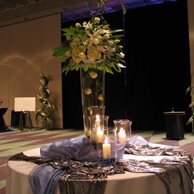 Cocktail area floral designs stood out against soft blue and silver table linens.