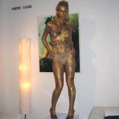 A model was covered in gold body paint and Swiss Watch International (SWI) logos.