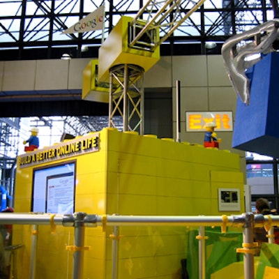 Google's trade show booth at the DigitalLife electronics show at the Javits Center featured a large yellow, central piece surrounded by red, green, and blue areas that represented different Google services.