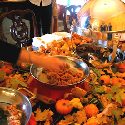 Plaza banquet staffers served coffee, spiced apple cider, and hors d'oeuvres like bruschetta and crab cakes on a table dotted with autumn leaves and mini pumpkins.