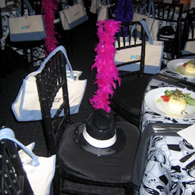 Chairs were draped with bright feather boas that matched the feather centerpieces, while alternating chairs had black hats resting on the cushions.