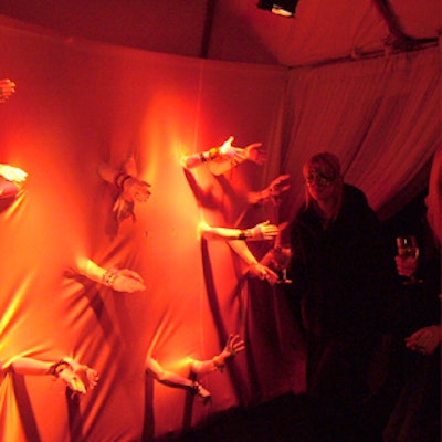 At Central Park Conservancy’s annual Halloween ball, human arms gestured and grabbed at passing guests from behind a fabric wall created by Matthew David Events.