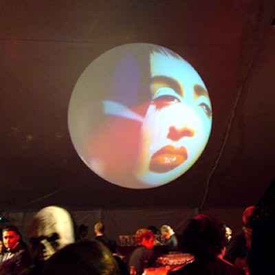 During the cocktail hour, abstract designs and human faces were projected on round screens hanging from the tent’s roof.
