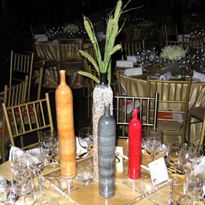 An arrangement of tall vases gave one table a vertical thrust.