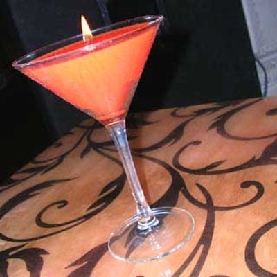 Orange candles mimicking the sidecar drink adorned tables, bar counters, and platforms.