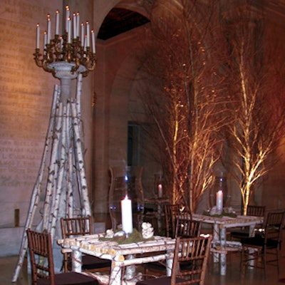 At the New York Public Library's Library Lions dinner, David Monn decorated Astor Hall with birch log cocktail tables, tall white pillar candles encased in oversize hurricane vases, and cut birch logs that flanked the tall candelabra.