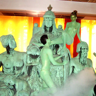 At the Dream hotel opening, body-painted performers perched on a sculpture in the lobby.