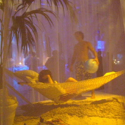 At the Aqua resort launch party at Splashlight Studios, a room with transparent fabric walls housed an idyllic beach scene—complete with a palm tree, hammock, and a swimsuit-wearing couple tossing around a beach ball.
