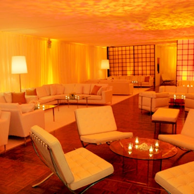 The lounge featured while leather couches, daybeds, and mirrors.