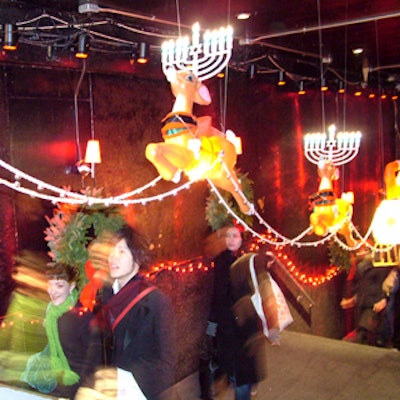 At the entrance, a team of plastic reindeer with menorahs for antlers pulled a plastic Santa up the staircase.