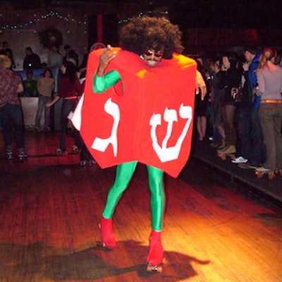Disco gear-clad staff in dreidel costumes danced in skates.