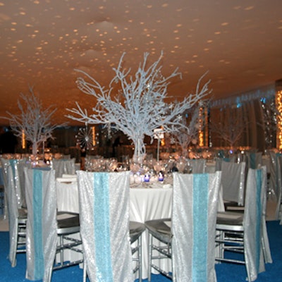 Bill Tansey used blue-flocked branches as centerpieces, covered tables with velvet linens, and draped chairs with silver and blue sequined covers.
