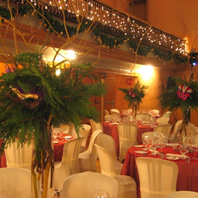 A festive colour palette of red and white linens and masked evergreen centerpieces from Earthworks enhanced the masquerade theme.