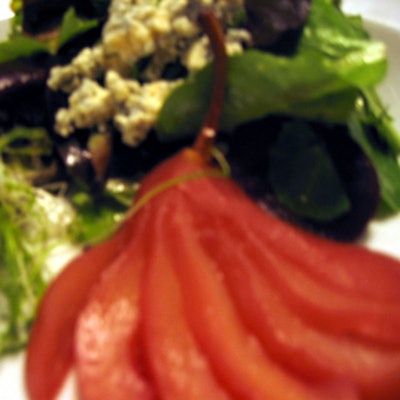 Opulence Catering created a mouthwatering menu including a baby green salad with champagne vinaigrette, crumbled Stilton, and fanned burgundy poached pear.