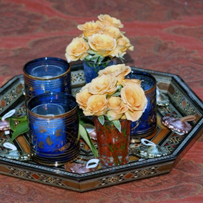 Centerpieces coordinated with cups of gold and red marigolds and inlaid bowls.