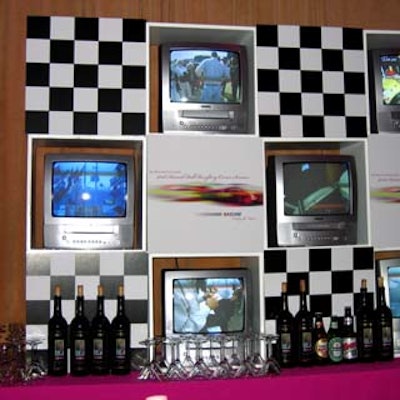 The bar was backed by TV screens showing racecar images as well as the cover of the ball's invitation.