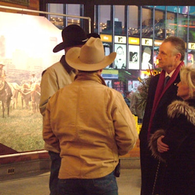 A cowboy hat-dotted crowd mingled in front of Tomik Productions’ stand-up structures featuring images of Fort Worth.