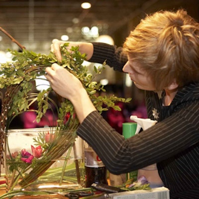 Daniella Pateman, of the Aragon Group, feverishly placed flowers during the 'Iron Florist' competition, which challenged four floral design teams to create the best arrangement in 30 minutes.