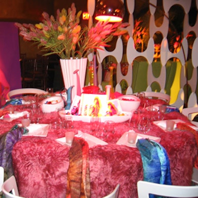 Jeffrey Grubb created a wild rock 'n' roll effect for the Hangtags for Humanity table-mixing a fuzzy red faux fur rug used as the tablecloth with long swaths of tie-dyed fabric looped around the folded napkins and draped down the edge of the table.