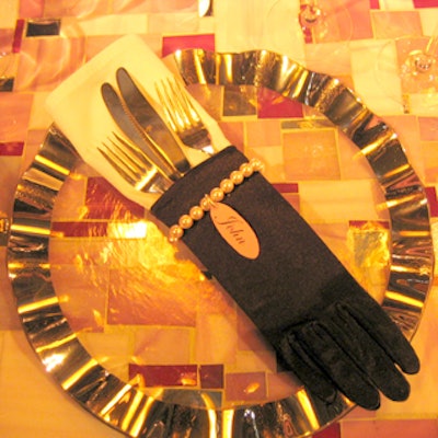 Artistic Tile founder and president Nancy Epstein placed forks and knives—but oddly, no spoons—in black gloves accented with beaded bracelets with placecards attached at each place setting.