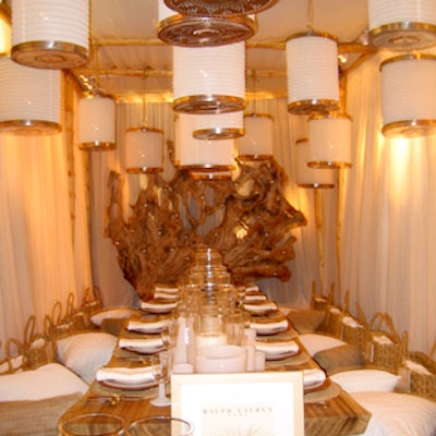 The Ralph Lauren Home space—one of the more spare designs that actually worked—was enclosed in white fabric, and decorated with a large piece of driftwood hung with small votives, paper lanterns, and bench seats covered in white and flax-colored pillows.