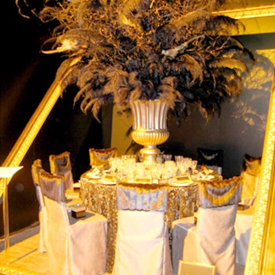 Matthew Smyth's ornate and ostentatious design for the Larson-Juhl sponsored table included a large gold frame set at an angle and an imposing centerpiece of black feathers in a gold-colored urn.