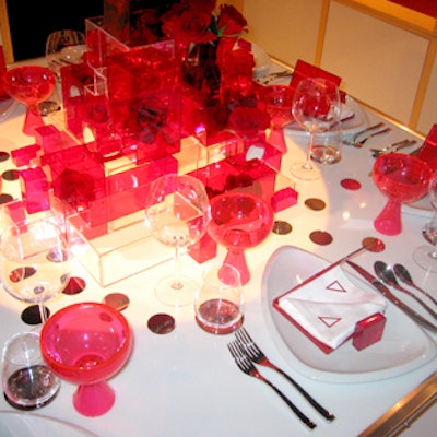 Red plastic goblets contrasted with traditional clear wine glasses at the Container Store’s red-and-white, modern-looking table.