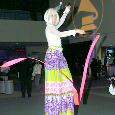 Circus-style performers on stilts twirled ribbons to entertain the crowd.
